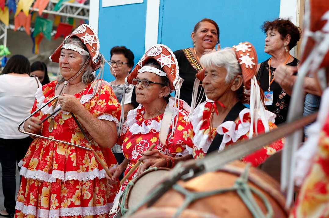 Small group of Brazilian people listening attentively in a circle