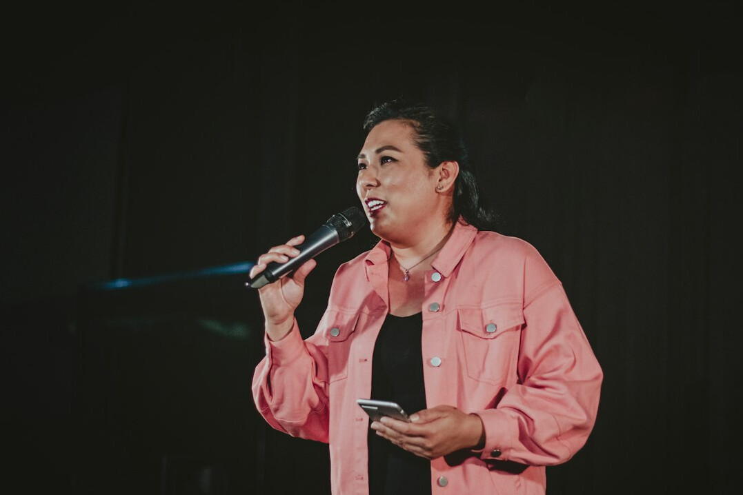 woman speaking confidently on stage