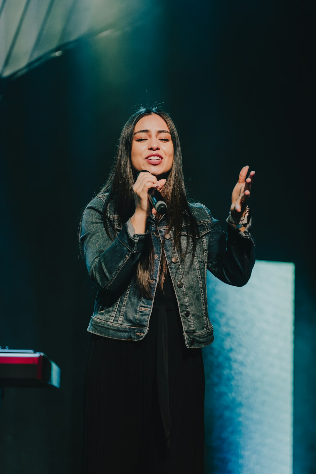 woman speaking confidently on stage