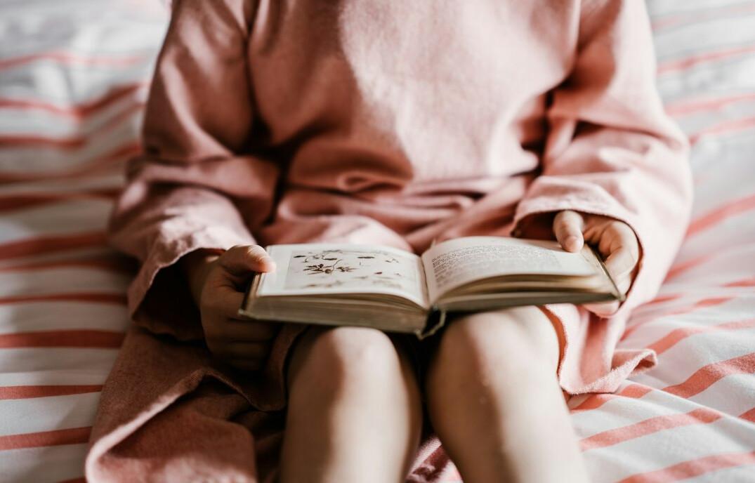 Brazilian person reading a book at home